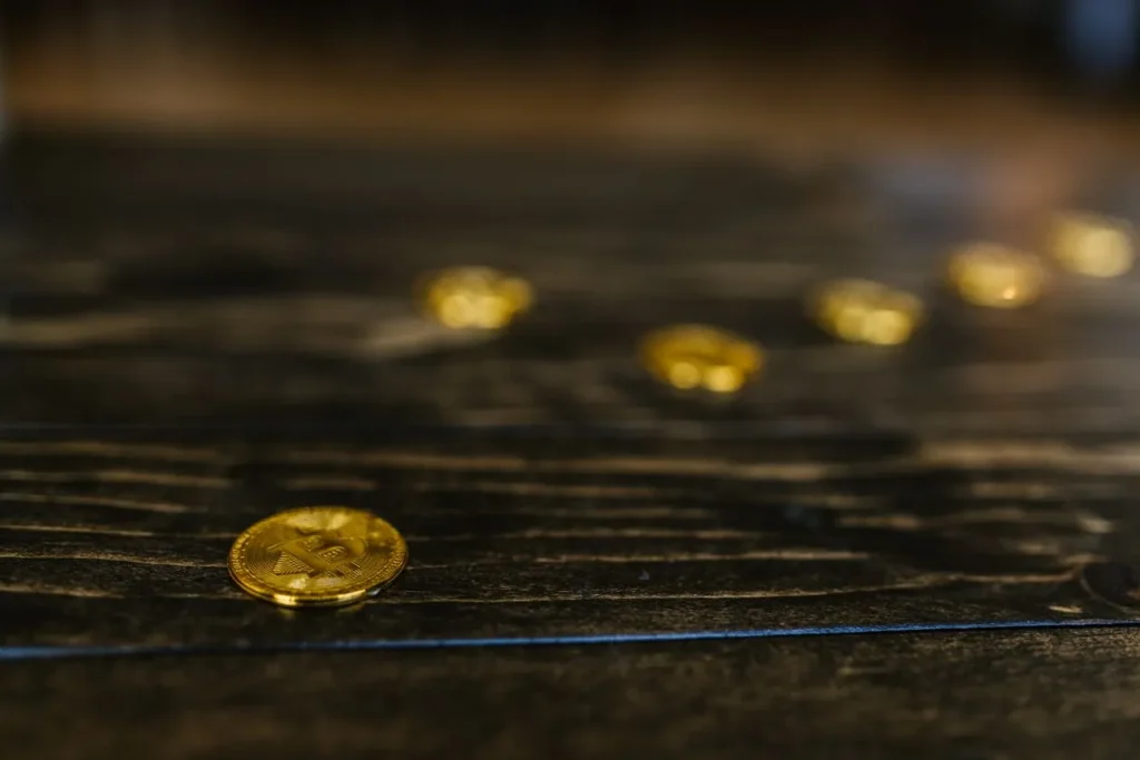 Digital Dollars Go Global as America Keeps Buying Bitcoin Gold Bitcoin coins arranged on a wooden table