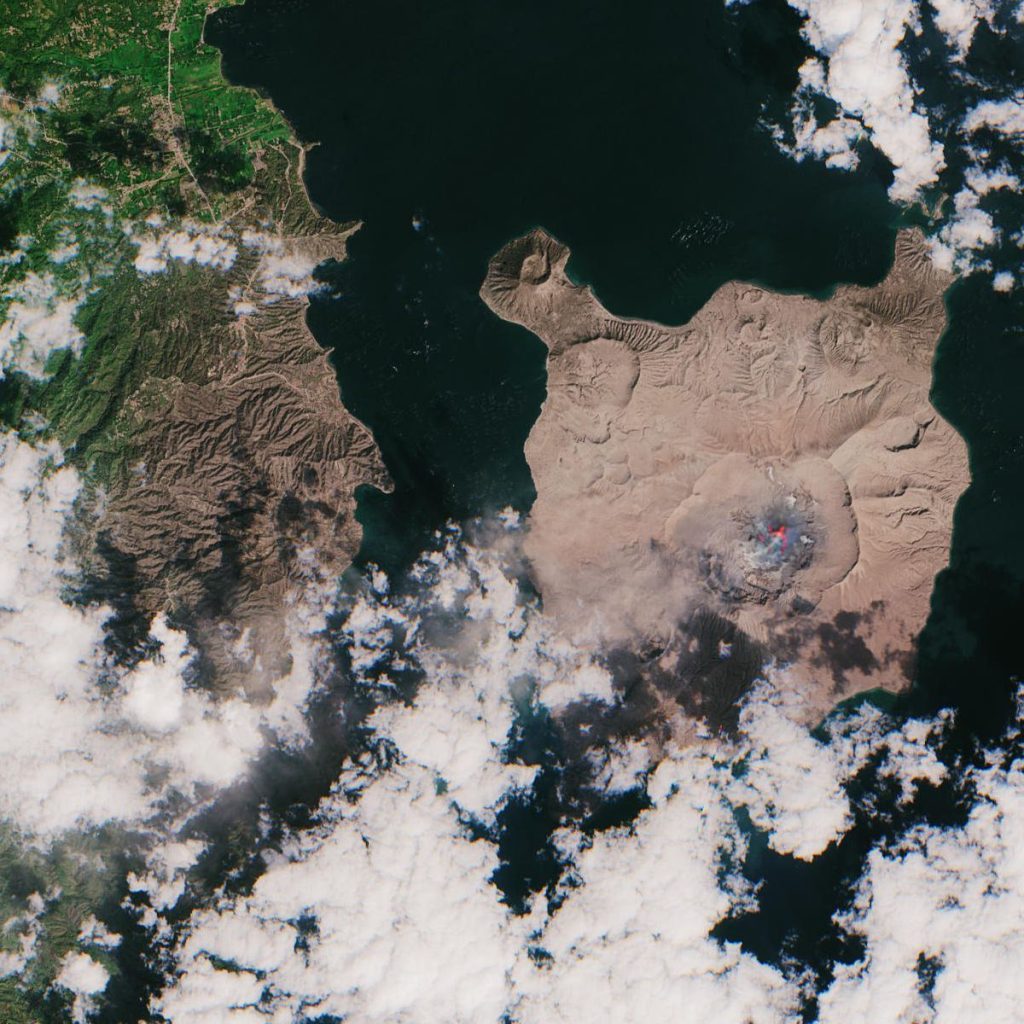 Faster Ash Cloud Modelling Helps Airlines Reroute Safely volcano erupting with an ash cloud over an island