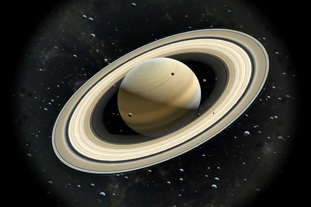 Saturn’s Moon Count Leaps to 274 After 128 New Moons Are Confirmed Saturn with its rings surrounded by many small moons in deep space